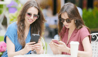 Women looking at smartphones